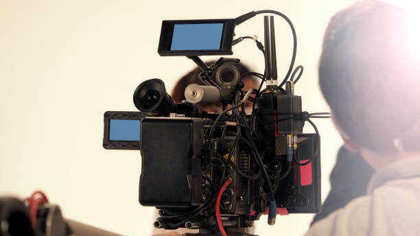 istock Behind the 4k high defination video camera shooting by film crew team in big studio production. 1663932236