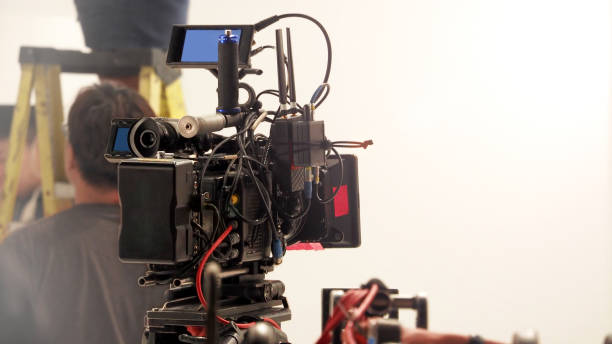 istock Behind the 4k high defination video camera shooting by film crew team in big studio production. 1663932237