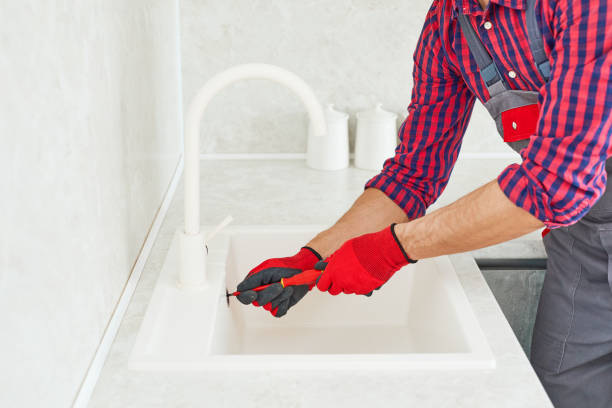 istock Plumber hands holds detail for installing in kitchen sink. Plumber Installing The Sink, plumbing work or renovation. 1663937039