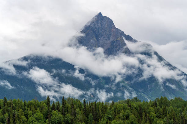 Hagwilget Peak, Hazelton, Canada Hagwilget mountain peak in the clouds, Hazelton, British Columbia, Canada. smithers british columbia stock pictures, royalty-free photos & images