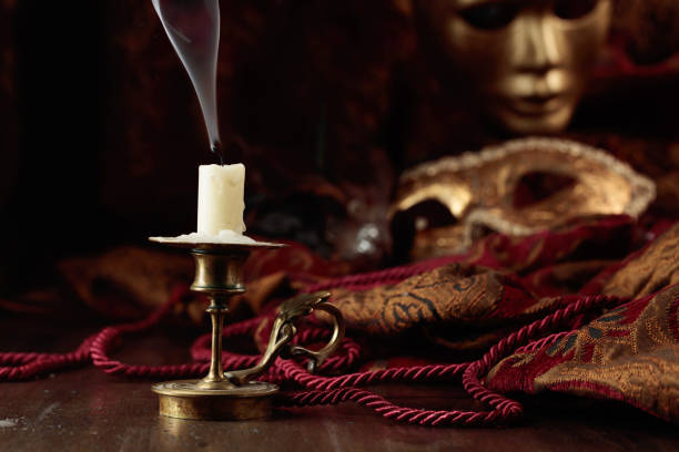 istock Still life with an extinguished candle and carnival masks. 1663938268