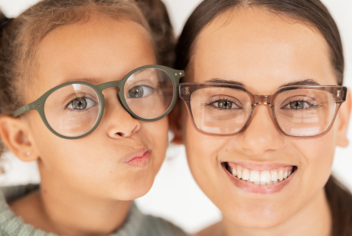 Family, optometry and eye care with glasses for mother and child together for vision, focus and eyesight with lens frame mockup. Portrait and face of woman and girl together for ocular health