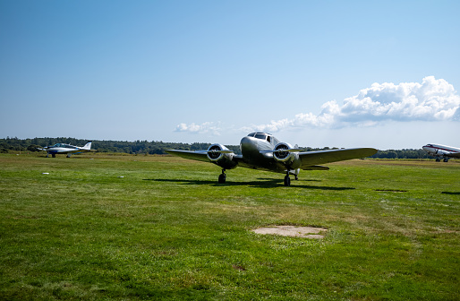 Views of a small private grass airstrip in Marstons Mills on Cape Cod in MA.  Many small planes are on the ground including several DC3s.  All runways for this airstrip are grass.