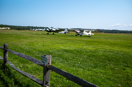 Views of a small private grass airstrip in Marstons Mills on Cape Cod in MA.  Many small planes are on the ground including several DC3s.  All runways for this airstrip are grass.