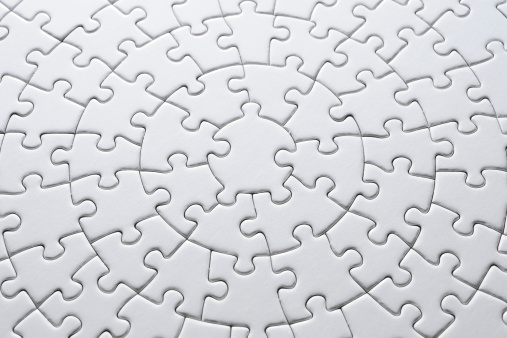 Close-up shot of blank circle white jigsaw puzzle.