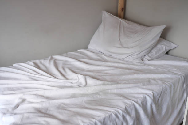 istock messy bed in early morning , messy bed after waking up 1663966321