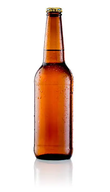Photo of Brown bottle of beer with drops on a white background