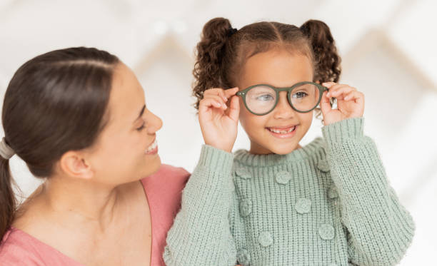istock Optometry, vision and mother with child with glasses after examination, test and diagnosis for eyesight. Family, healthcare and happy girl with new spectacles in doctor office after optical exam 1663983473