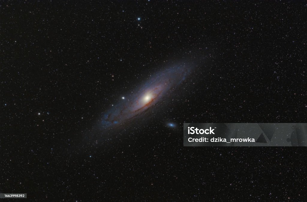 Andromeda Galaxy (M31) and its satellite galaxies (M32 and M110) in Andromeda constellation against widefield night starry sky Abstract Stock Photo