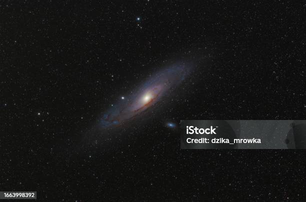 Andromeda Galaxy In Andromeda Constellation Against Widefield Night Starry Sky Stock Photo - Download Image Now