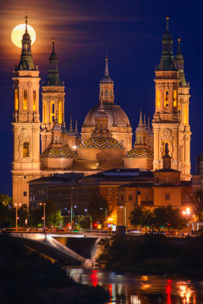 Super Moon on August 31, 2023 behind tower of the Basilica of Our Lady of the Pilar.