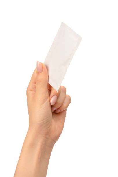 istock Wet wipe in a woman hand isolated on a white background. 1664023193