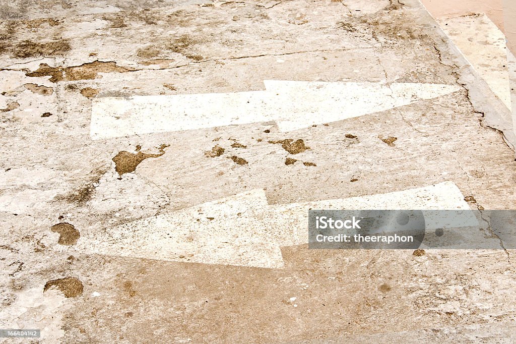 arrow on street Arrow on the cement floor. And cement floor is very old. Asphalt Stock Photo