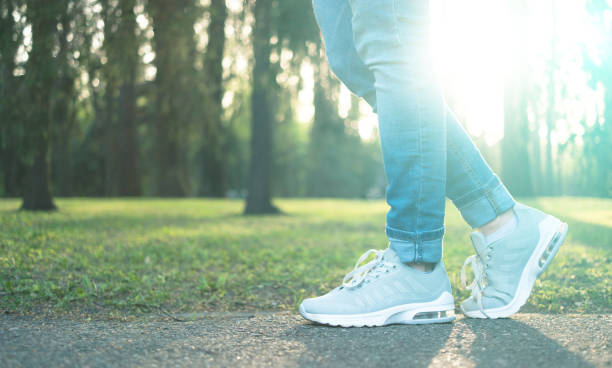 istock Person walking in gray running shoes, closeup 1664065700