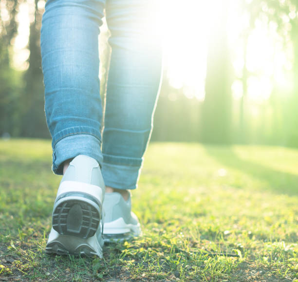 istock Walking in gray running shoes, back to camera 1664065884