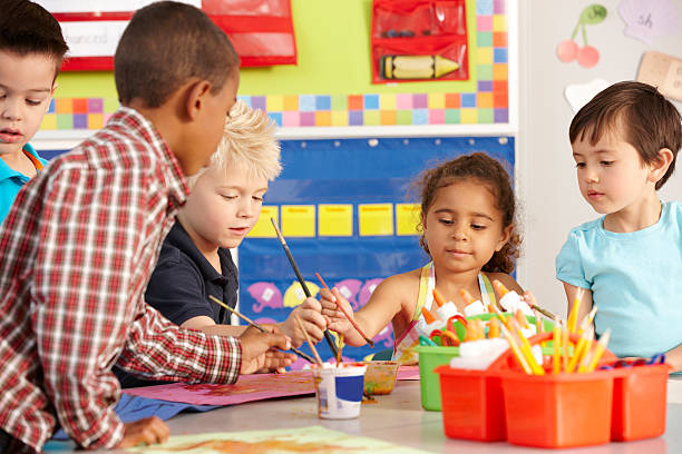 istock Group Of Elementary Age Schoolchildren In Art Class 166407307