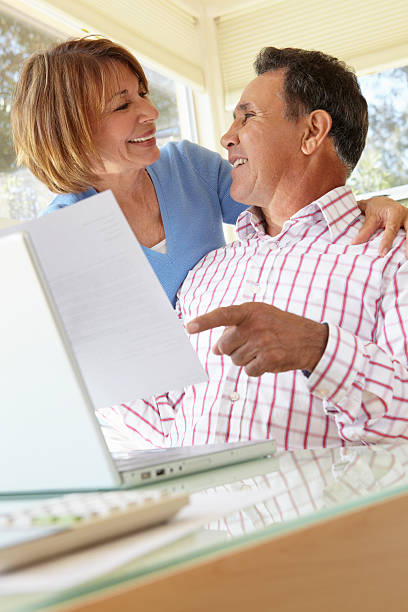 istock Senior Hispanic Couple Working In Home Office 166407466