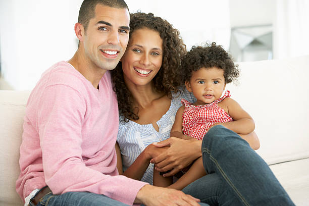 istock Young Family Relaxing On Sofa 166408978