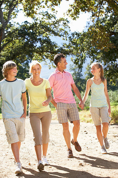 istock Middle Aged Family Walking Through Countryside 166409168