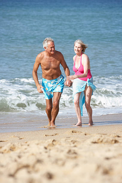 istock Senior Couple Enjoying Beach Holiday 166409619