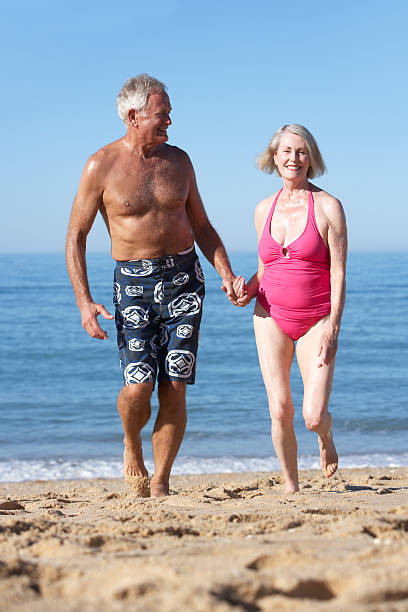 istock Senior Couple Enjoying Beach Holiday 166409656