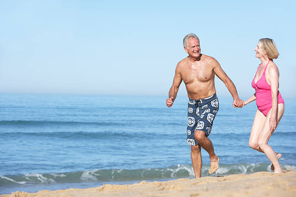 istock Senior Couple Enjoying Beach Holiday 166409912