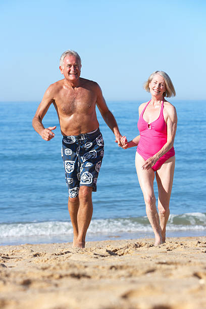 istock Senior Couple Enjoying Beach Holiday 166409926