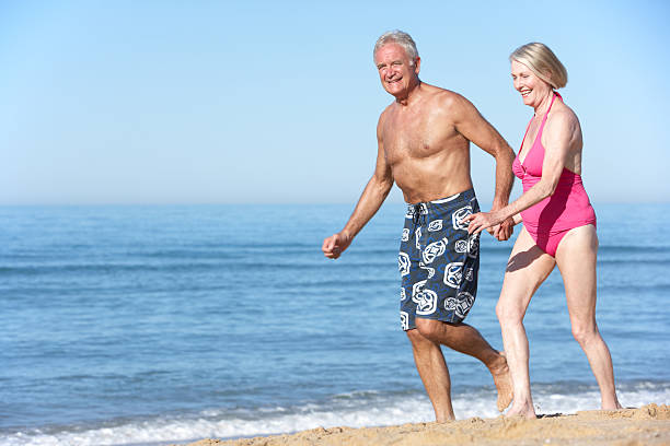 istock Senior Couple Enjoying Beach Holiday 166409995