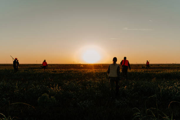 istock A group of hunters walking towards the sunrise 1664107031