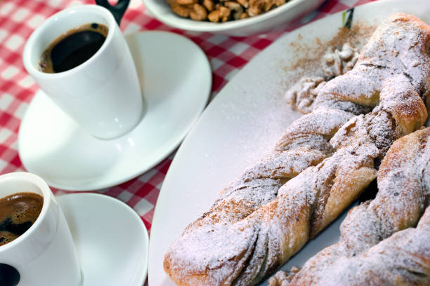Crispy walnut strudel on white plate and coffee