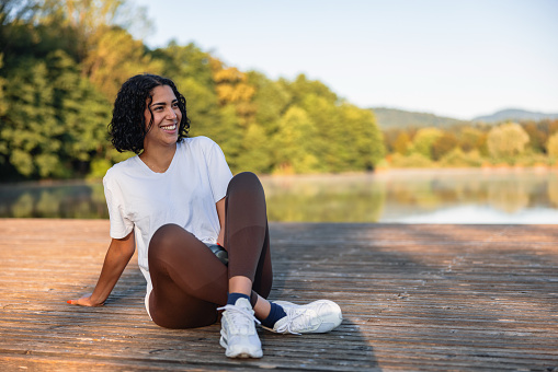 Hispanic Female Teenager Relaxing Near A Lake