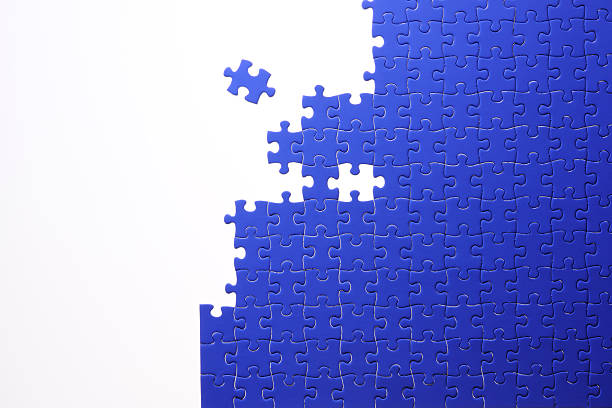 istock Isolated shot of blue jigsaw puzzle on white background 166416397