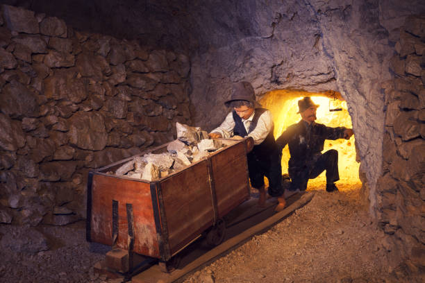 Mining Process From Its Early Beginnings Exhibited child and father figures deep underground in a lead mine - represent different ways of a mining process and also the tools and the equipment used for ore digging in the mine in different periods of the history of the mine, from its early beginnings 330 years ago (Mezica, Slovenia). lead mining stock pictures, royalty-free photos & images