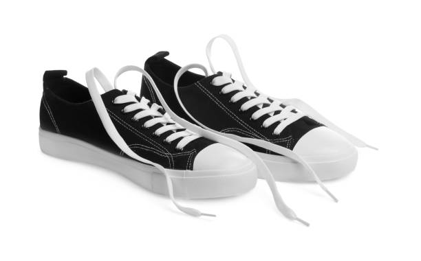 istock Pair of black classic old school sneakers isolated on white 1664169655