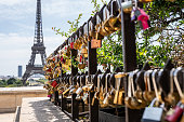 Hundreds of romantically loving inscribed padlocks in Paris, France.Eiffel Tower in the background.