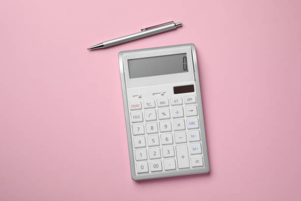 istock Calculator and pen on pink background, flat lay 1664170747