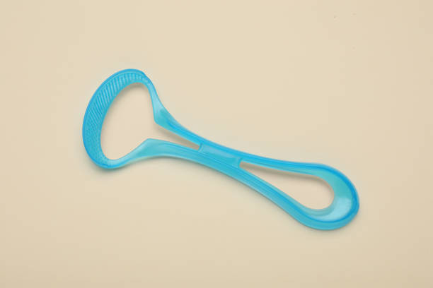 istock Light blue tongue cleaner on beige background, top view 1664171805