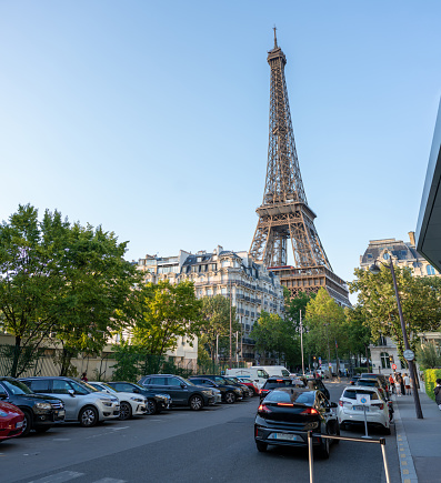 Urban street scene in Paris, France, with the Eiffel Tower in the background.