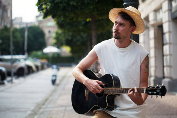 istock Street musician playing the guitar 1664203349