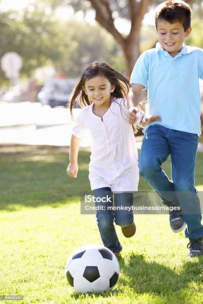 Две дети играют в футбол вместе - Стоковые фото Играть роялти-фри