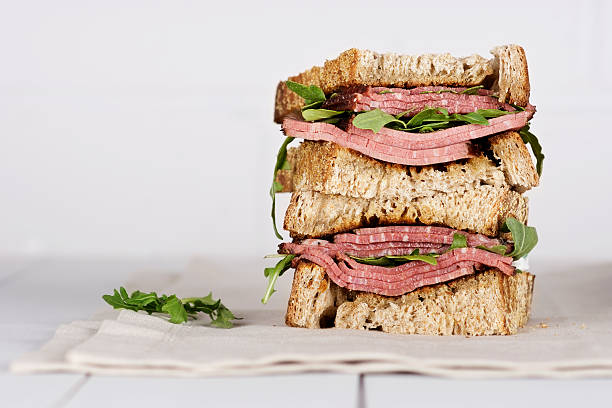 Pastrami Sandwich Pastrami sandwich on white wood table pastrami photos stock pictures, royalty-free photos & images
