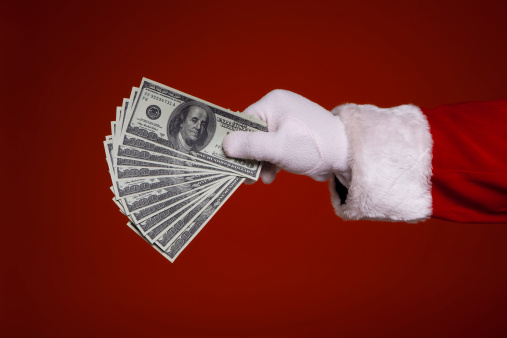 Santa Claus hand giving money 