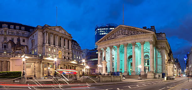 Bank of England in the City of London A bus driving past the statue of the Duke of Wellington in front of the Royal Exchange. The Bank Of England to the left. London, UK. bank of england stock pictures, royalty-free photos & images