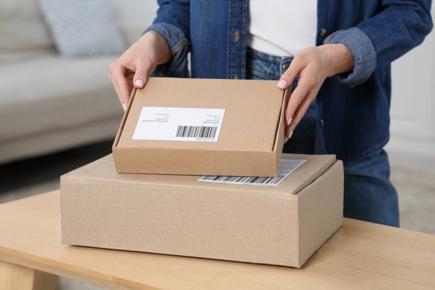 istock Woman unpacking parcel at home, closeup. Online store 1664233937