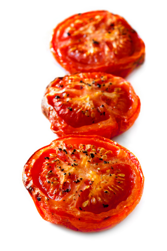 Roasted tomatoes isolated on white background.