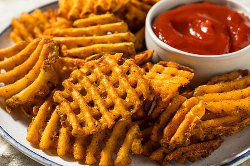 Salty Organic Waffle French Fries with Seasoning and Ketchup