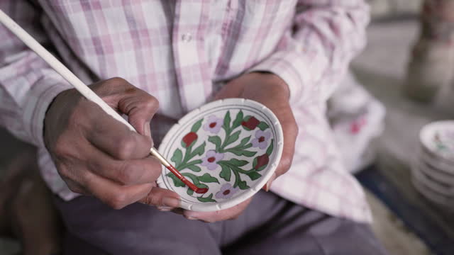 Man painting Jaipur's Blue Pottery, Rajasthan, India