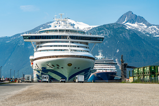 Skagway, Alaska - July 30, 2023: Carnival Luminosa and Sapphire Princess moored at cruise pier in the morning in Skagway, Alaska, USA.