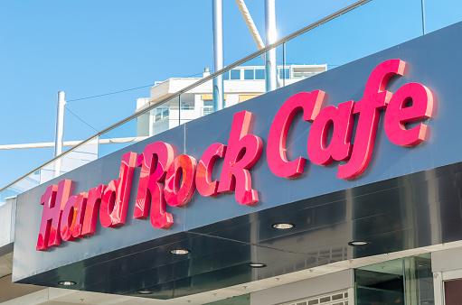 Malaga, Spain - October 12, 2021: Logo of the famous Hard Rock Cafe in Malaga, Spain. Hard Rock Cafe, Inc. is a British-American multinational chain of theme restaurants, memorabilia shops, casinos and museums founded in 1971 by Isaac Tigrett and Peter Morton in London
