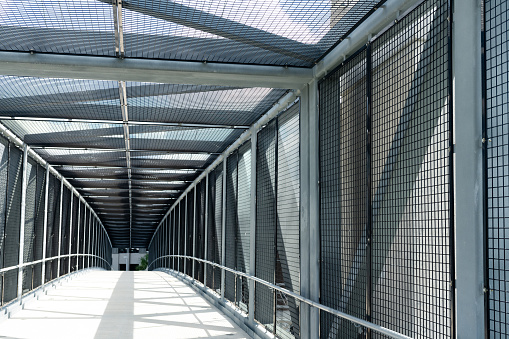 In Orlando, Florida this pedestrian walkway is enclosed with wire and the perspective leads to a vanishing point.